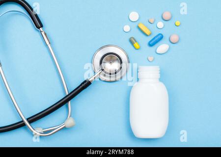 White bottle with pills and capsules in the form of a heart and the phonendoscope Stock Photo