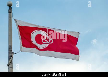 A flag of Calgary on a pole during the day. Stock Photo