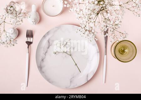 Romantic table setting in pink colors. White flowers decor Stock Photo