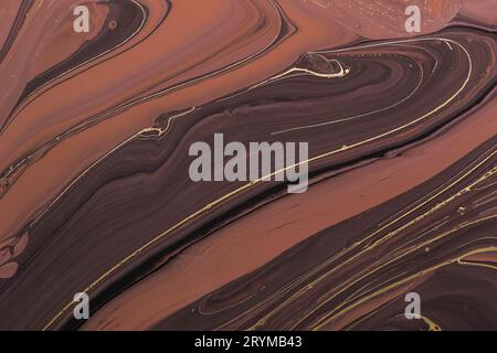 Fluid Art. Abstract Golden lines on brown waves. Marbling background or texture Stock Photo