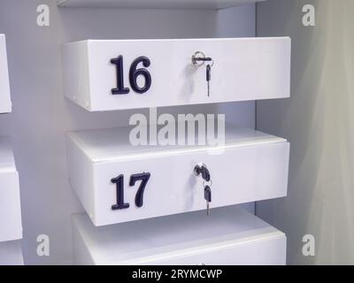 Boxes in the post office. Mini safe with key. The concept of secure storage. Box numbers 16 and 17. Personal mailbox Stock Photo