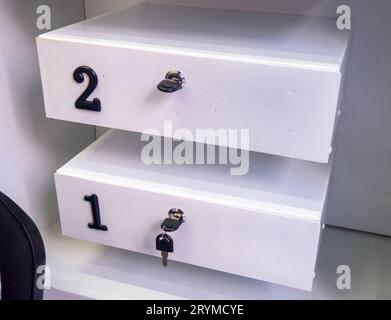 Boxes in the post office. Mini safe with key. The concept of secure storage. Box numbers 2 and 1. Personal mailbox Stock Photo