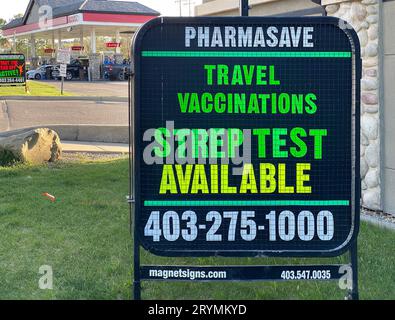 Calgary, Alberta, Canada. May 17, 2023. A Pharmasave pharmacy sign offering Strep test and travel vaccinations. Stock Photo