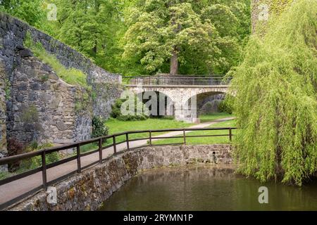 Bridge in park Antique aged stone. castle style wall Stock Photo