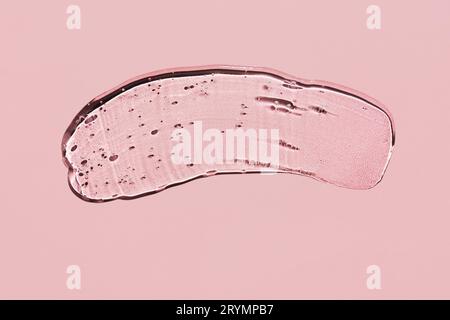 Transparent liquid gel on pink background. Textured smear with oxygen bubbles Stock Photo