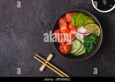 Hawaiian salmon poke salad with rice, vegetables and seaweed served in bowl Stock Photo