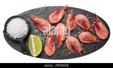 Boiled shrimp on a board, lime slices, spices on a white background, top view Stock Photo