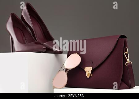 Burgundy high heels, handbag and pink sunglasses Stock Photo