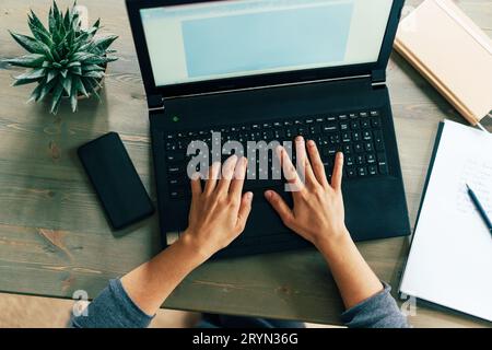 Hands on laptop keyboard Stock Photo