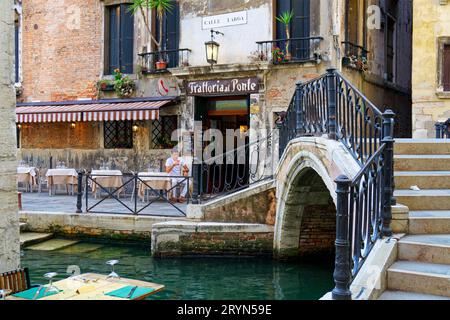 Small restaurant on a canal in Venice, Italy Stock Photo