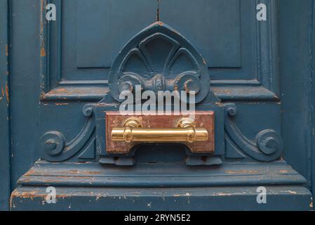 Brass door handle on an old front door, Paris, France Stock Photo