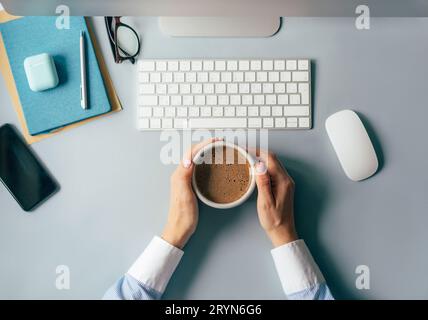 Coffee break at the workplace in the office. Work creative process. Stock Photo