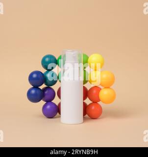 White plastic bottle with a dispenser for cosmetics on a beige background Stock Photo