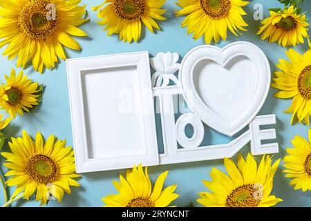 Picture frame, Sunflower photo frame with copy space on pastel blue background. Stock Photo