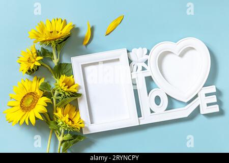 Picture frame, Sunflower photo frame with copy space on pastel blue background. Stock Photo