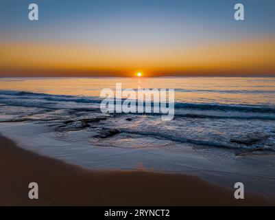 Sunrise seascape with clear skies at Shelly Beach on the Central Coast, NSW, Australia. Stock Photo