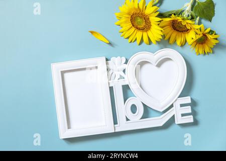 Picture frame, Sunflower photo frame with copy space on pastel blue background. Stock Photo