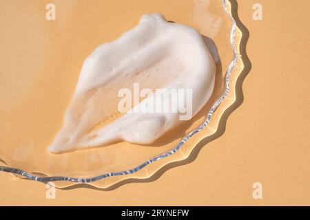 Soap foam on a light beige background. Stock Photo