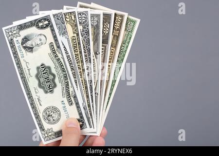 Old Philippine money in the hand on a gray background Stock Photo