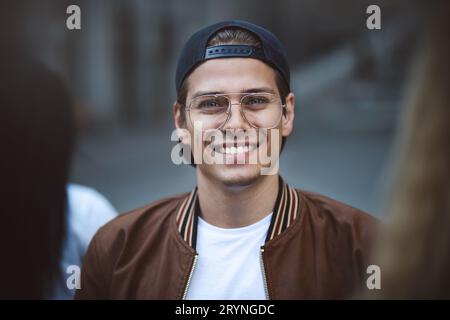 Young happy man posing on a crowded street Stock Photo