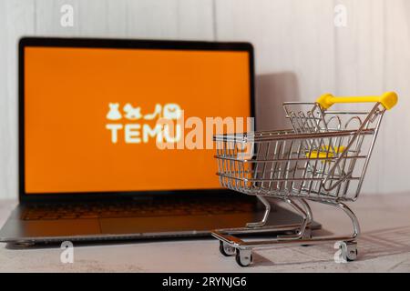 Gdansk, Poland - March 2023 Temu app icon in screen of MacBook Apple computer laptop with shopping cart. Temu subsidiary of Chin Stock Photo