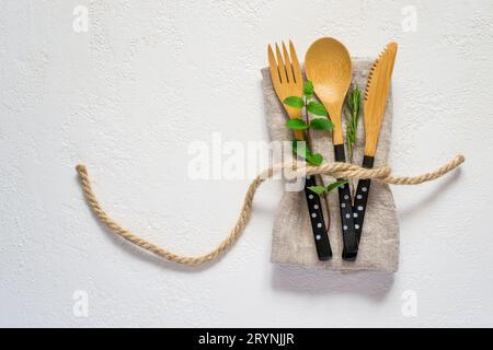 Set of bamboo cutlery and napkin on a white background. Natural Stock Photo