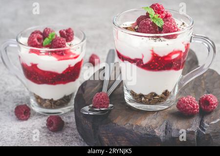 Raspberry healthy dessert or breakfast with natural yogurt in glass mugs Stock Photo