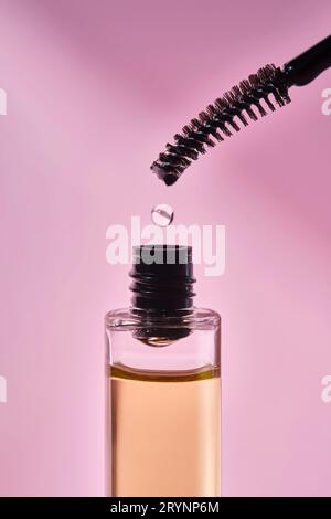 Cosmetic oil for the growth of eyebrows and eyelashes with a brush. Stock Photo