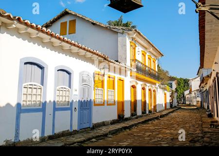 Typical colonial two and one story houses with colorful doors and windows on sunny day in historic t Stock Photo