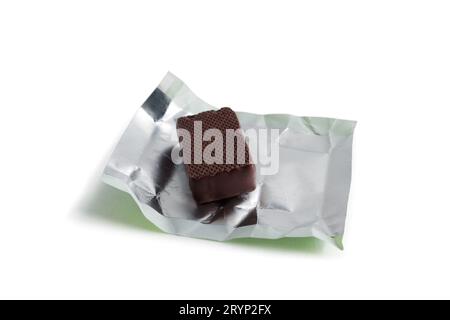 Unwrapped chocolate candy. Close-up. Isolated on white background. Stock Photo
