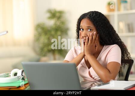 Concerned black student e-learning looking at you complaining at home Stock Photo