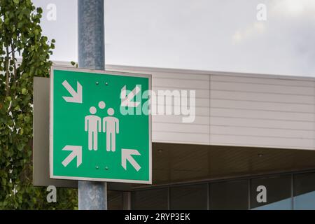 Green assembly point sign outside the building in Finland. Stock Photo