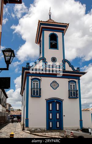 Front view to small beautiful chapel in white and blue against blue sky with white clouds in histori Stock Photo