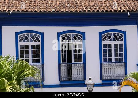 Close-up front view of an historical building with three windows in white and blue, Diamantina, Mina Stock Photo