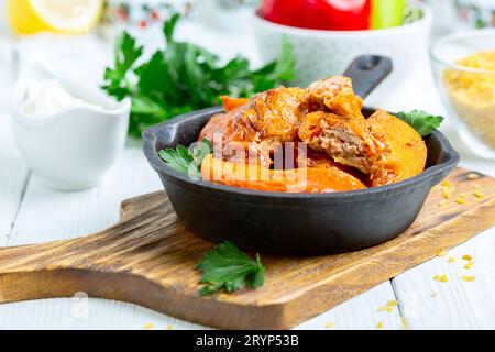 Stuffed cabbage rolls with meat and bulgur in tomato sauce. Stock Photo