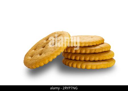 Side view stack of crunchy salted round crackers isolated on white background. Stock Photo