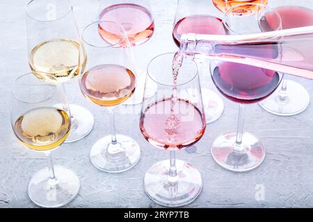 Rose wine pour into a glass at a tasting. Rose, red, and white wine, drinks Stock Photo