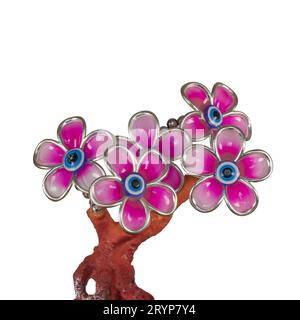 Pink decorative artificial flowers in the form of a figurine. Isolated on white background. Stock Photo