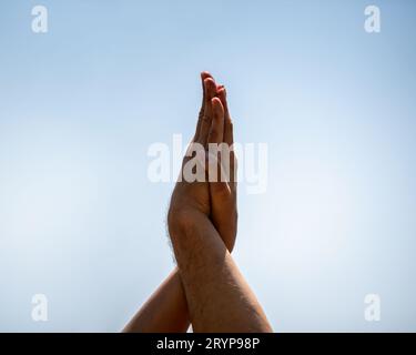 Hands of people doing yoga on the beach Stock Photo