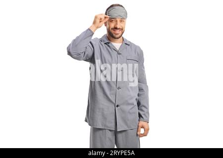 Happy man in pajamas with a sleeping mask isolated on white background Stock Photo