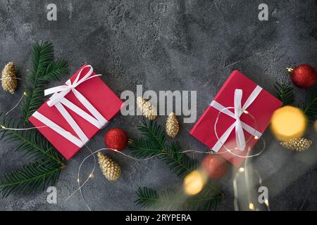 Christmas composition with gifts, decoration and lights with bokeh on dark background. Flat lay Stock Photo