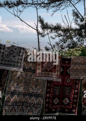 hanged colorful carpets against the sky Stock Photo
