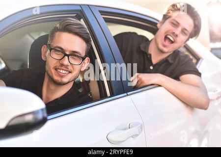 Young caucasian couple in car having fun on road trip Stock Photo