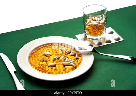 A plate and a glass with vitamins and other medical preparations. Stock Photo