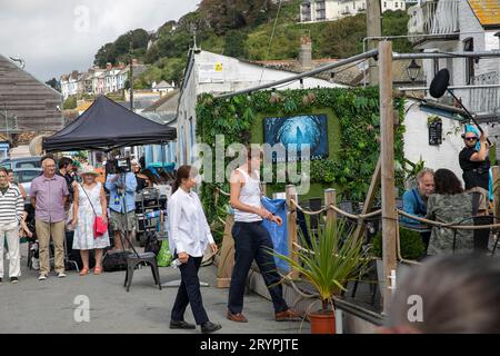Beyond Paradise BBC television series, live filming in Looe Cornwall in September 2023, actors Kris Marshall and Zahra Ahmadi perform in a scene,UK Stock Photo