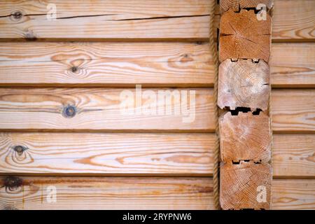 Natural background pattern of log wall. Construction of houses made of wood, profiled timber Stock Photo