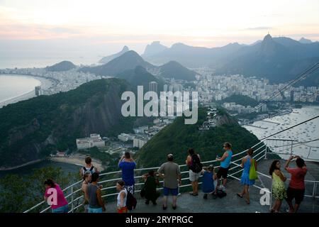 People on top of the Pao Asucar or Sugar loaf mountain with a view over the city, Rio de Janeiro, Brazil. Stock Photo