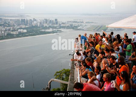 People on top of the Pao Asucar or Sugar loaf mountain with a view over the city, Rio de Janeiro, Brazil. Stock Photo