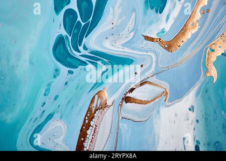 Acrylic Fluid Art. Gold, blue and turquoise flowing waves. Abstract marble background or texture Stock Photo