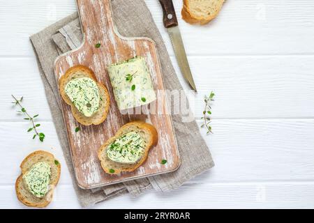 Sandwiches with herbs butter On Cutting board on white wooden background Stock Photo